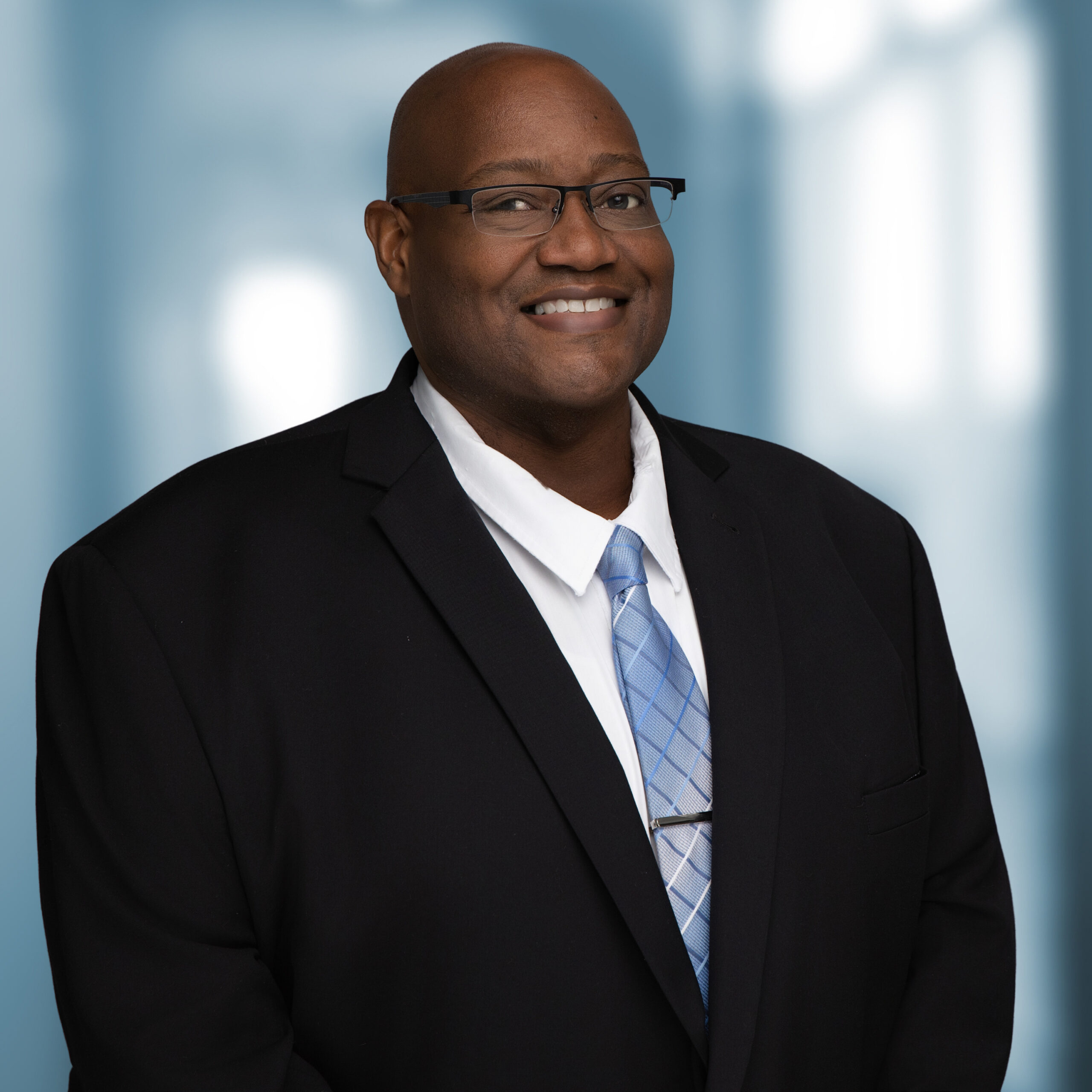 Elissa Henry of Homestead Estate Lawyers smiling in a professional black dress portrait