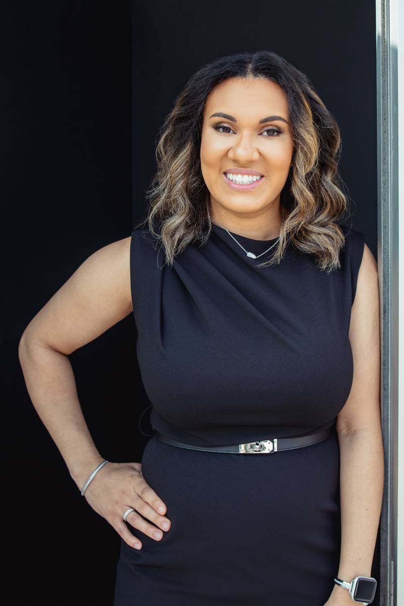 Elissa Henry of Homestead Estate Lawyers smiling in a professional black dress portrait
